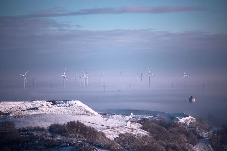 Foggy winter morning with wind turbines