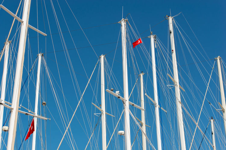 Ship mast in the port of bodrum, turkey in front of cloudless sky
