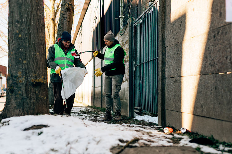 Volunteer elderly people clean up the street from garbage