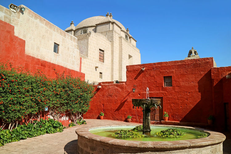 Courtyard of the convent of santa catalina de siena with a vintage stone fountain, arequipa, peru