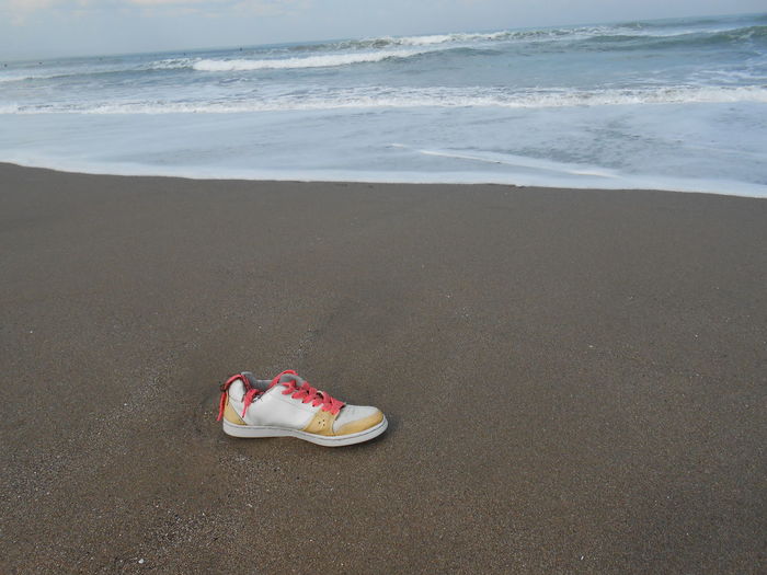 High angle view of shoes on beach