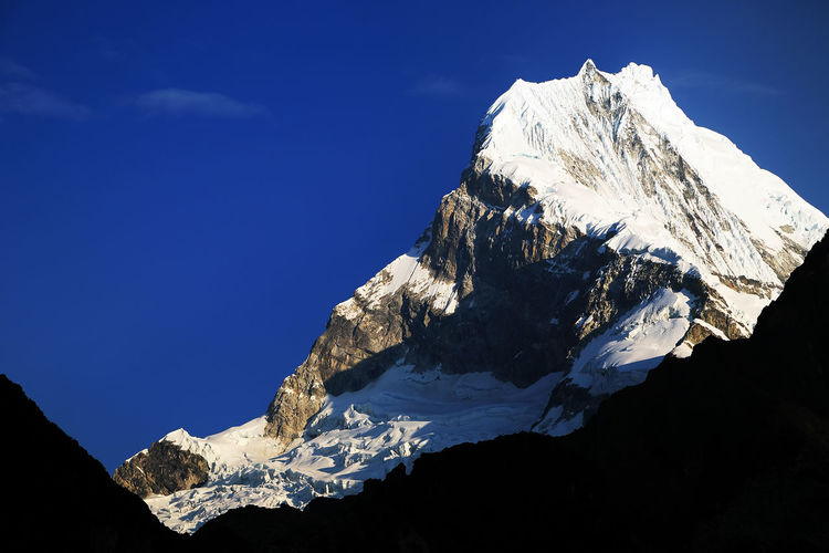 Snowcapped mountain peak against sky