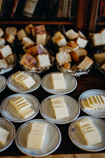 High angle view of bread with cheese slices in plates on table at wedding ceremony