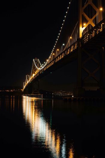 Illuminated bridge over river