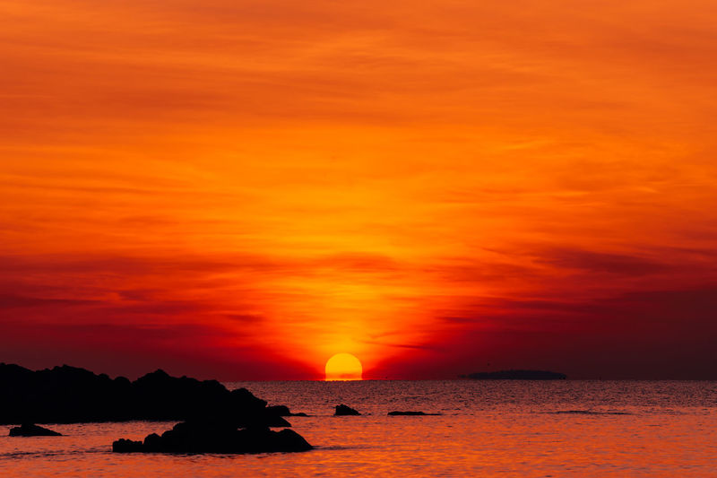 Scenic view of sea against romantic sky at sunset