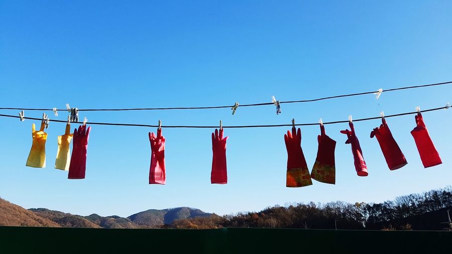 Clothes drying on clothesline against clear sky