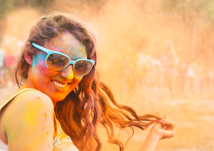 Portrait of a smiling woman playing holi