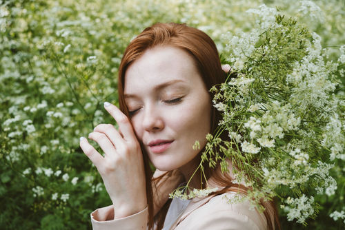 PORTRAIT OF BEAUTIFUL YOUNG WOMAN WITH FLOWER PLANTS