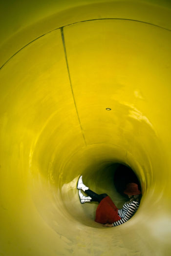 Woman resting in yellow slide
