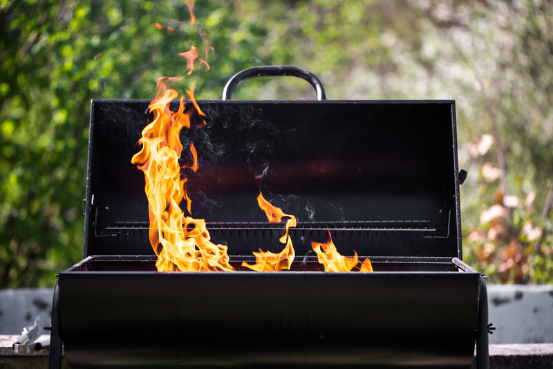 Close-up of fire on barbecue grill in yard