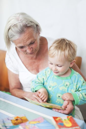 Grandmother with grandson reading greeting cards, sweden
