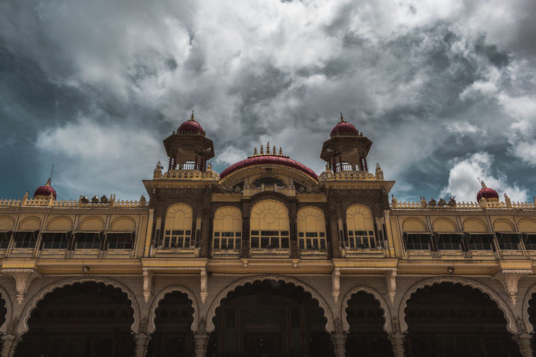 Low angle view of historic building against cloudy sky