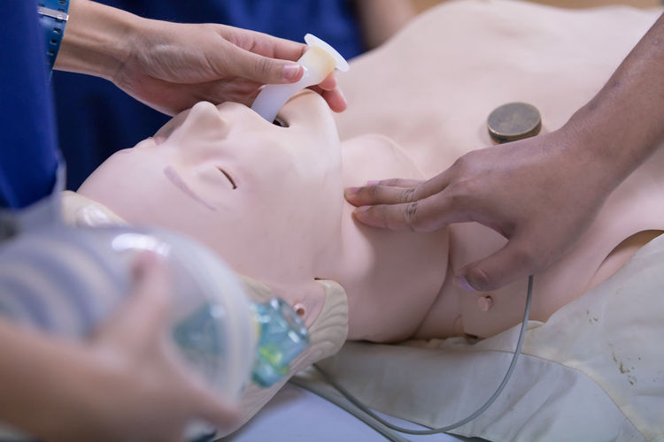 Cropped image of person learning cpr in hospital