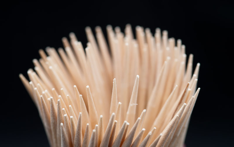 Close-up of toothpicks against black background