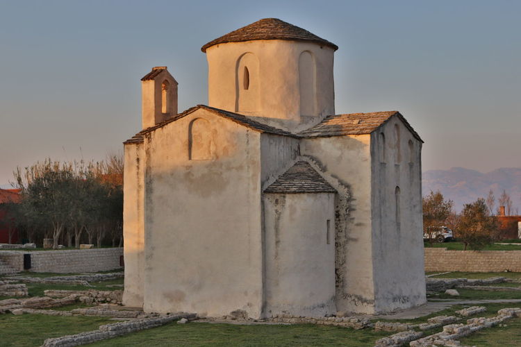 Old building on field against sky