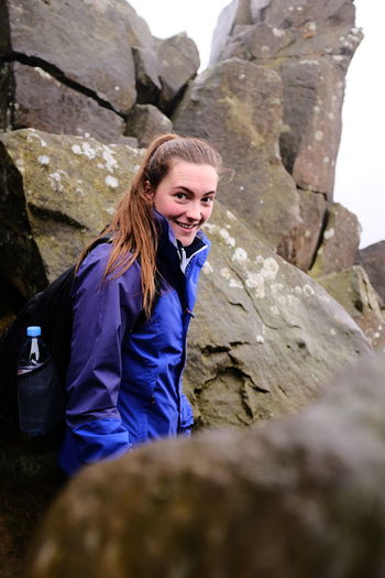 Low angle view of woman sitting on rock