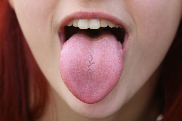 Close-up of woman sticking out tongue