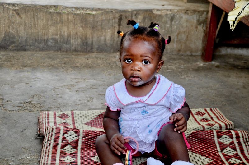Portrait of cute girl sitting on carpet