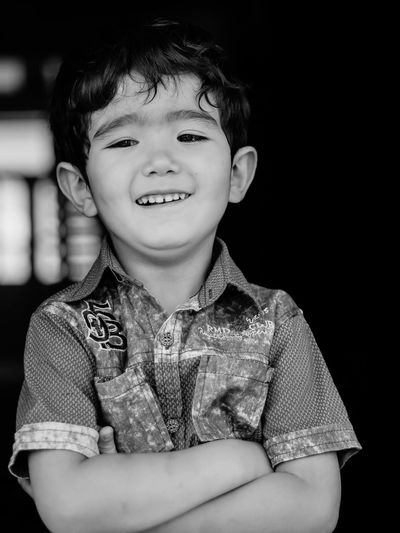 Portrait of smiling boy standing indoors