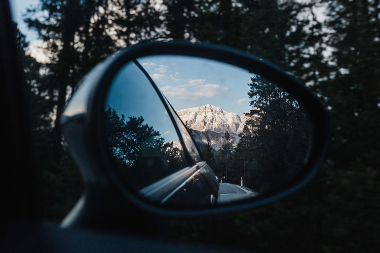 Reflection of mountain in side-view mirror