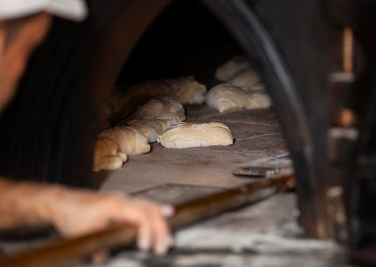 Close-up of man preparing bread in bakery