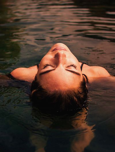Close-up of young woman swimming in pool
