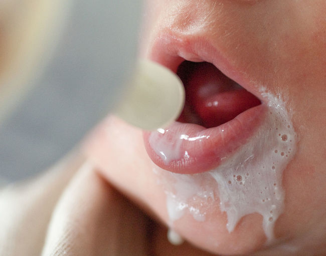 Cropped image of baby feeding milk