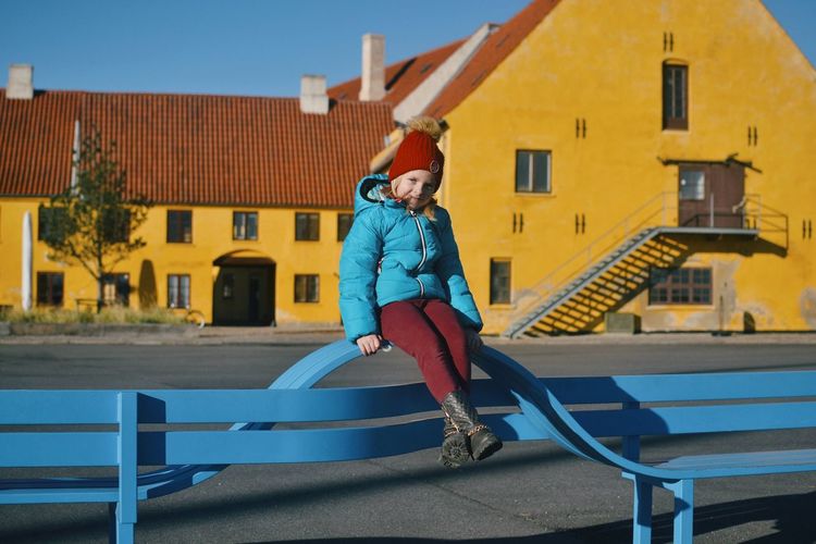 Full length of girl on playground against building