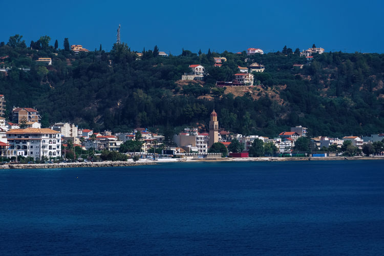 View of town by sea against clear sky