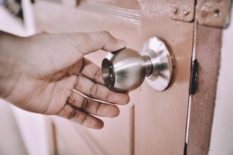 Close-up of hand holding door knob