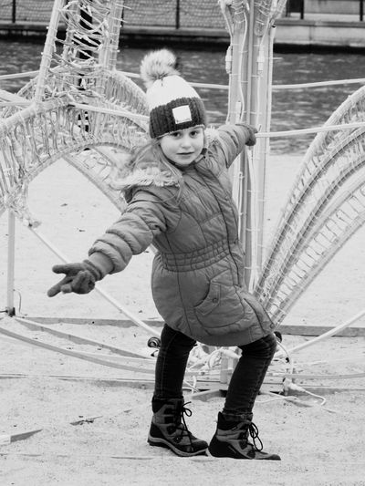 Portrait of girl gesturing while standing by railing