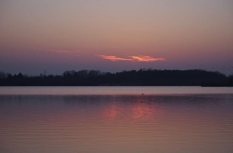 Scenic view of lake against sky during sunset