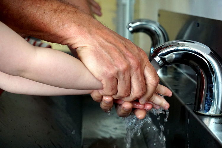Cropped image of washing hands