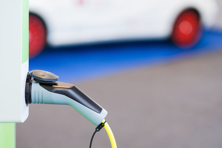Close-up of car charger at charging station