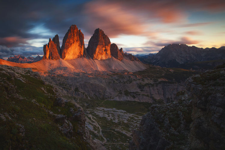 Rock formations on landscape against sky during sunset