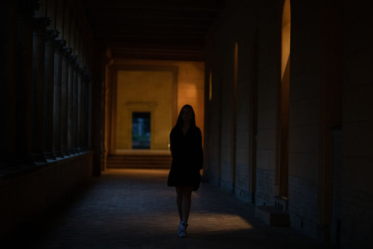 Woman walking in corridor of building