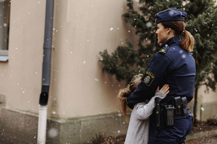 Police woman hugging daughter