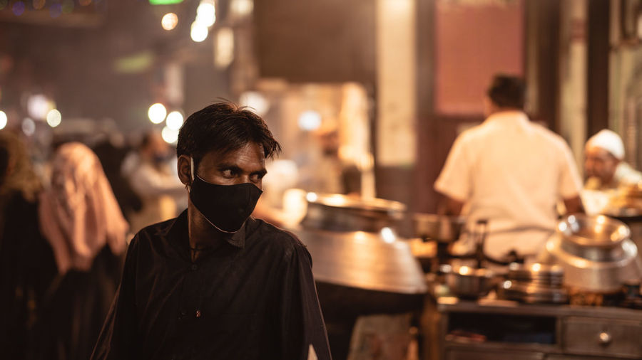 Man wearing a mask in a food street