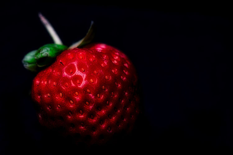 Close-up of strawberry over black background