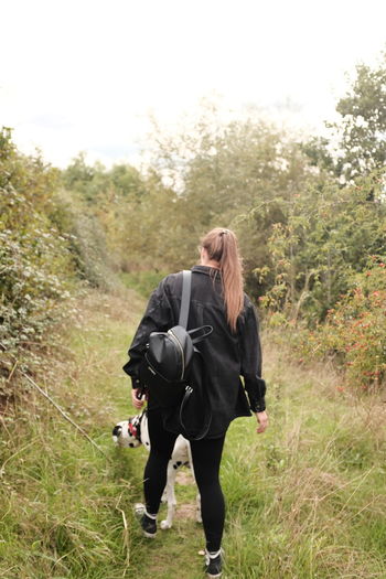 Rear view of woman standing on field