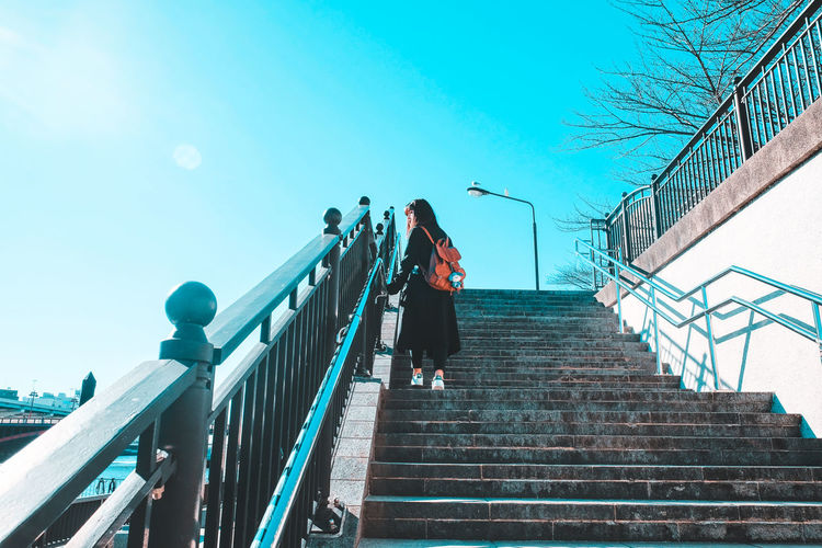 Low angle view of woman walking on staircase