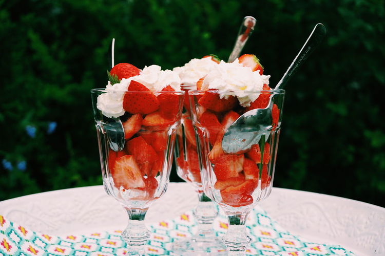Close-up of strawberries with whipped cream in tray
