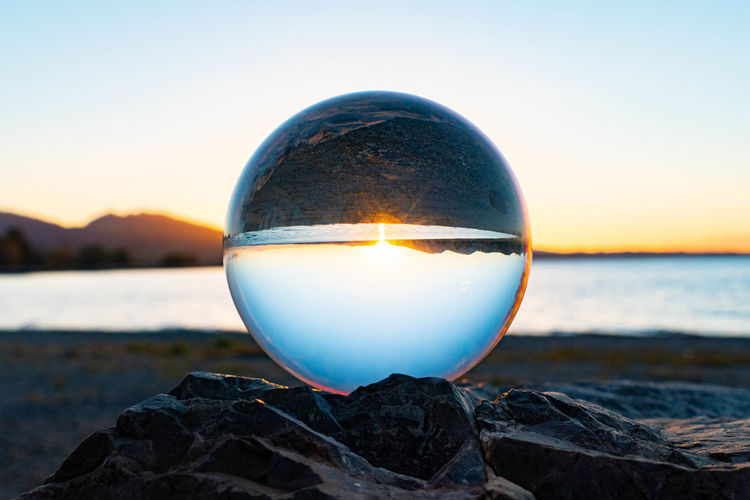 Lensball on a stone at sunset by the lake of constance