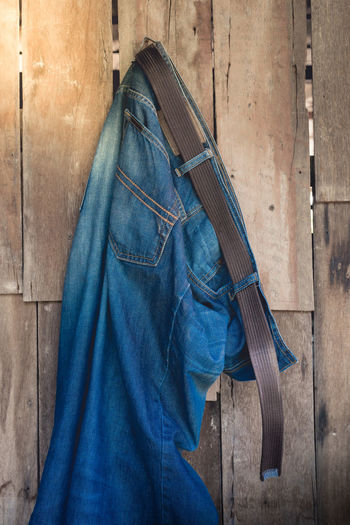 Jeans hanging on wooden wall