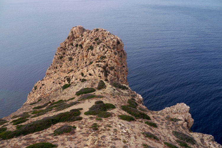 High angle view of rock formations on sea shore