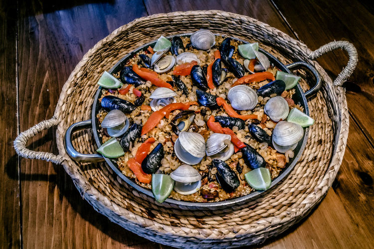 High angle view of paella served in saucepan on table