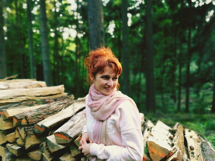 Portrait of smiling woman in forest