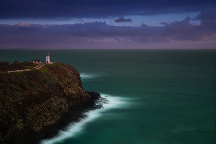 Long time exposure of mystical morning in twilight with lighthouse on the hawaii island kauai.