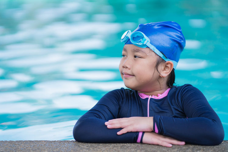 Portrait of cute girl playing in swimming pool
