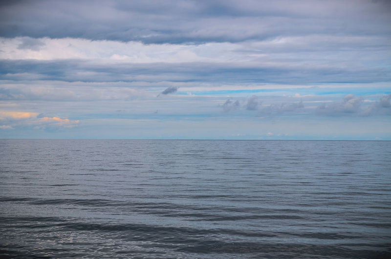 Scenic view of baltic sea against cloudy sky at dusk